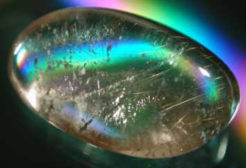 We don't know what type of stone it is, but this photo of a beautiful gem stone ... iridescent under the light ... was taken by Carole Nickerson of Halifax, Canada.  Can anyone tell us what type of gemstone it is?